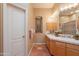 This bathroom has tile flooring, wooden cabinets, double sinks, and decorative accents at 5892 E Carefree Mountain Dr, Carefree, AZ 85377