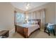 Cozy bedroom features a wood bed frame and a scenic window with neutral tones at 5892 E Carefree Mountain Dr, Carefree, AZ 85377