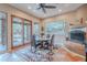 Charming dining area with a fireplace and views of the backyard pool at 5892 E Carefree Mountain Dr, Carefree, AZ 85377