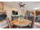 Cozy dining area with a fireplace, a television and a view of the kitchen at 5892 E Carefree Mountain Dr, Carefree, AZ 85377