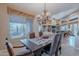 Elegant dining room features a decorative chandelier and scenic views from the expansive window at 5892 E Carefree Mountain Dr, Carefree, AZ 85377