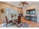Dining room with a glass table, fireplace, and window view of the outdoor landscape at 5892 E Carefree Mountain Dr, Carefree, AZ 85377