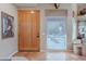 Inviting entryway with tile flooring, a wooden door and transom window at 5892 E Carefree Mountain Dr, Carefree, AZ 85377