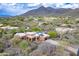 Desert home featuring sleek architectural design with a three-car garage and beautiful desert landscaping at 5892 E Carefree Mountain Dr, Carefree, AZ 85377