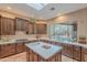 Bright kitchen featuring dark wood cabinets, white countertops, and a large window with pool views at 5892 E Carefree Mountain Dr, Carefree, AZ 85377