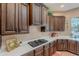 Gourmet kitchen features custom cabinetry, tile flooring, and a gas cooktop, perfect for culinary enthusiasts at 5892 E Carefree Mountain Dr, Carefree, AZ 85377