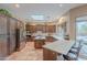 Bright kitchen featuring custom wood cabinets, stainless steel appliances, and a breakfast bar with stool seating at 5892 E Carefree Mountain Dr, Carefree, AZ 85377