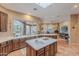 Large kitchen features a center island, tile flooring, a large window, and plenty of countertop space at 5892 E Carefree Mountain Dr, Carefree, AZ 85377
