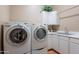 Functional laundry room featuring a modern washer and dryer plus a utility sink at 5892 E Carefree Mountain Dr, Carefree, AZ 85377