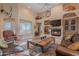 Inviting living room with natural light, terracotta floors, and a charming fireplace at 5892 E Carefree Mountain Dr, Carefree, AZ 85377