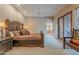 Spacious main bedroom boasts a rustic wood bed frame and sliding door access to the outdoors at 5892 E Carefree Mountain Dr, Carefree, AZ 85377