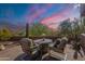 Inviting outdoor patio featuring comfortable seating and desert views at sunset at 5892 E Carefree Mountain Dr, Carefree, AZ 85377