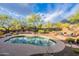 Landscaped backyard oasis with a refreshing pool and an outdoor seating area at 5892 E Carefree Mountain Dr, Carefree, AZ 85377