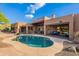 A beautiful backyard featuring a shimmering pool and lovely desert landscaping around the rear exterior of the home at 5892 E Carefree Mountain Dr, Carefree, AZ 85377