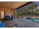 Relaxing covered patio space next to a sparkling pool with desert landscaping at 5892 E Carefree Mountain Dr, Carefree, AZ 85377
