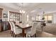 Elegant dining room showcasing a modern chandelier, table, and seamless connection to the cozy living space at 729 W Silver Reef Dr, Casa Grande, AZ 85122