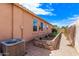 Landscaped yard with garden bed, window views and AC unit at 729 W Silver Reef Dr, Casa Grande, AZ 85122
