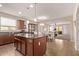Open-concept kitchen with a central island, stylish pendant lighting, and seamless flow to the dining area at 729 W Silver Reef Dr, Casa Grande, AZ 85122
