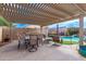 Covered patio with outdoor dining set, ideal for entertaining and relaxation at 729 W Silver Reef Dr, Casa Grande, AZ 85122