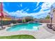 Inviting backyard pool with mature landscaping, rock features and mural backdrop at 729 W Silver Reef Dr, Casa Grande, AZ 85122