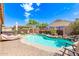 Resort-style backyard featuring a sparkling pool, lounge area, and desert mural at 729 W Silver Reef Dr, Casa Grande, AZ 85122
