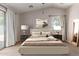 This bedroom features neutral tones, a light-colored bed, and a sliding glass door providing backyard access at 7365 W Magdalena Ln, Laveen, AZ 85339