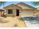 Charming single-story home with a low-maintenance desert-style front yard and attached two-car garage at 7365 W Magdalena Ln, Laveen, AZ 85339