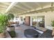 Comfortable covered back patio with stylish furniture, plants, and string lights for relaxing and entertaining at 7719 N 17Th Ave, Phoenix, AZ 85021