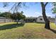Large, fenced backyard with mature trees, lawn, and picnic table at 7719 N 17Th Ave, Phoenix, AZ 85021