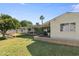 Backyard with a well-maintained lawn, patio, and mature trees providing shade and privacy at 7719 N 17Th Ave, Phoenix, AZ 85021