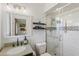 Modern bathroom with a walk-in glass shower, granite countertop, and decorative mirror at 7719 N 17Th Ave, Phoenix, AZ 85021