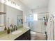 Bright bathroom with a shower over bath, and dark wood vanity at 7719 N 17Th Ave, Phoenix, AZ 85021