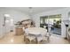 Elegant dining area with a round table, modern chairs, and a sliding glass door leading to the outdoors at 7719 N 17Th Ave, Phoenix, AZ 85021