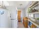 Functional laundry room with washer, dryer, and shelving at 7719 N 17Th Ave, Phoenix, AZ 85021