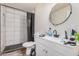 Bathroom with a white sink vanity, toilet, and a tiled shower with a shower curtain at 7746 W Osborn Rd, Phoenix, AZ 85033