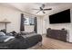 Bedroom with a ceiling fan, neutral walls, and wood-look tile flooring at 7746 W Osborn Rd, Phoenix, AZ 85033