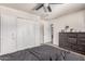 Bedroom includes a closet, dresser, and overhead fan at 7746 W Osborn Rd, Phoenix, AZ 85033