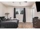 Bedroom with a window, neutral walls, and wood-look tile flooring at 7746 W Osborn Rd, Phoenix, AZ 85033