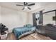 Bedroom with a ceiling fan, neutral walls, and wood-look tile flooring at 7746 W Osborn Rd, Phoenix, AZ 85033