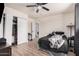 Bedroom with a ceiling fan, neutral walls, and wood-look tile flooring at 7746 W Osborn Rd, Phoenix, AZ 85033