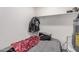 Bedroom features a shelf, hot water heater, and window at 7746 W Osborn Rd, Phoenix, AZ 85033