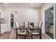 Bright dining room with wood-look tile, table and chairs, and view to the rear patio at 7746 W Osborn Rd, Phoenix, AZ 85033
