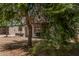 This showcases a quaint home partially shaded by lush tree, set in its yard at 7746 W Osborn Rd, Phoenix, AZ 85033