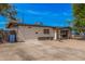 This charming residence boasts a low fence with gravel landscaping, and a long driveway at 7746 W Osborn Rd, Phoenix, AZ 85033