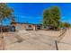 This property features a low fence with gravel landscaping, and a long driveway at 7746 W Osborn Rd, Phoenix, AZ 85033