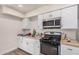 View of kitchen with stainless steel appliances, white cabinetry, and wood countertops at 7746 W Osborn Rd, Phoenix, AZ 85033