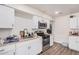 View of kitchen with stainless steel appliances, white cabinetry, and wood countertops at 7746 W Osborn Rd, Phoenix, AZ 85033