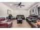 Bright living room featuring wood floors, a ceiling fan and comfortable seating at 7746 W Osborn Rd, Phoenix, AZ 85033