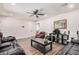 This bright living room features hard wood floors, a ceiling fan and comfortable seating at 7746 W Osborn Rd, Phoenix, AZ 85033