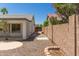 Private backyard with gravel landscaping, brick wall, and covered patio, offering a tranquil outdoor space at 7924 W Hammond Ln, Phoenix, AZ 85043